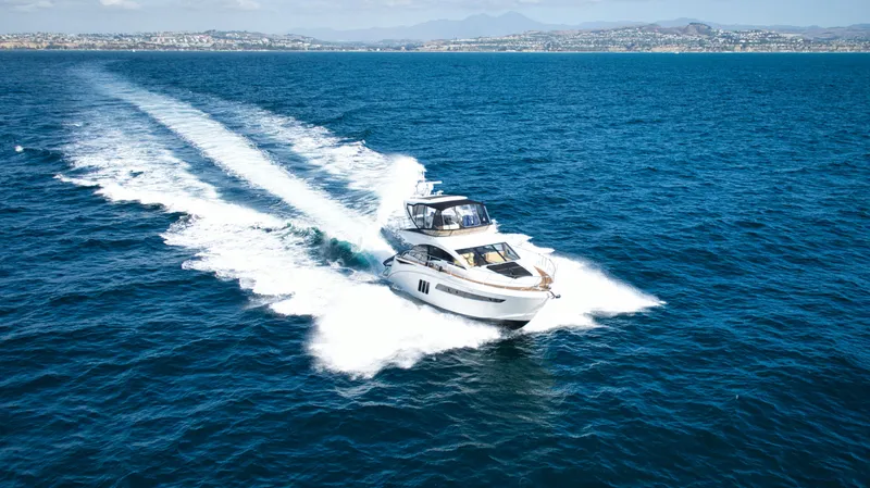 Slide: The Image of 2018 Sea Ray Fly 510 yacht cruising on open blue ocean. - 5
