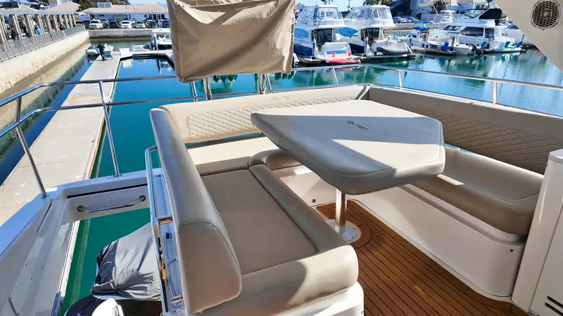 Slide: The Image of Luxurious 2018 Sea Ray Fly 510 yacht with elegant seating in a marina. - 53