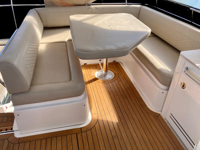Slide: The Image of Luxurious seating area on 2018 Sea Ray Fly 510 yacht with elegant wood flooring. - 54