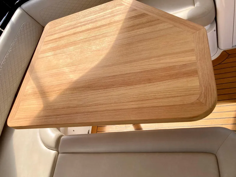 Slide: The Image of Wooden table on 2018 Sea Ray Fly 510 yacht, surrounded by beige seating. - 59