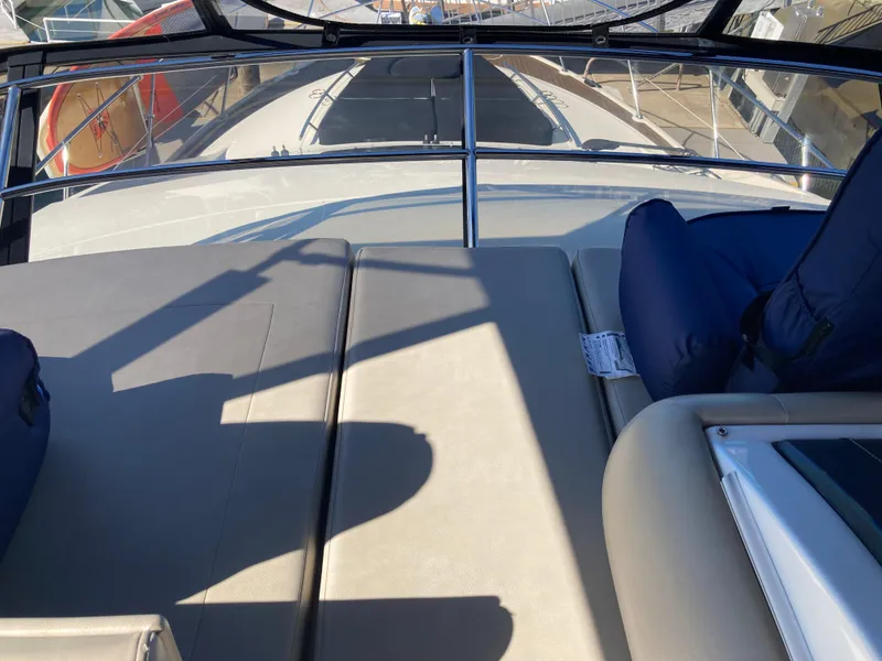 Slide: The Image of 2018 Sea Ray Fly 510 yacht deck with cushioned seating and railing. - 64