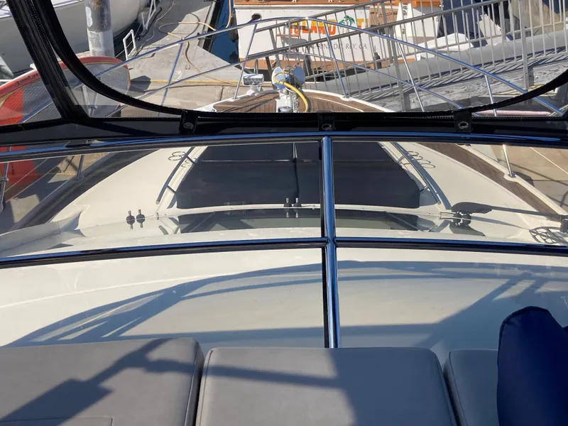Slide: The Image of 2018 Sea Ray Fly 510 yacht deck view with marina background. - 65