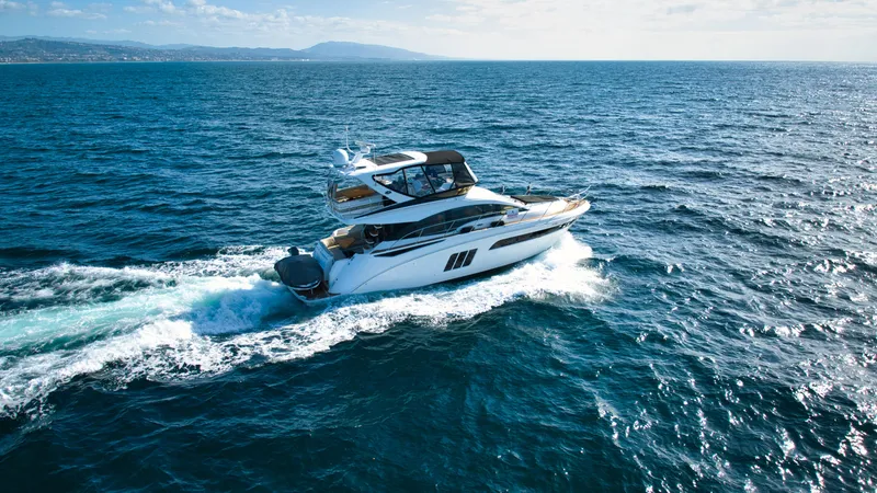 Slide: The Image of 2018 Sea Ray Fly 510 yacht cruising on open ocean waters. - 7