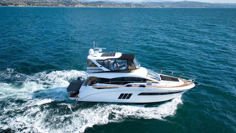 Slide: The Image of 2018 Sea Ray Fly 510 yacht cruising on open water. - 8