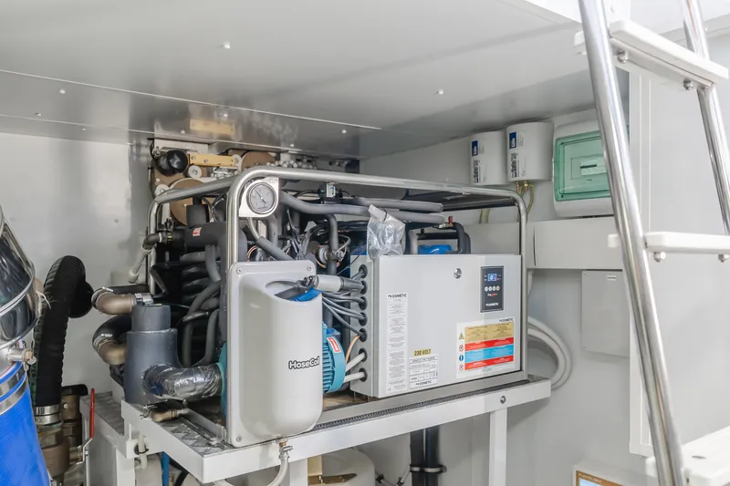 Slide: The Image of Engine room of 2023 Azimut Magellano 66 yacht, showcasing mechanical equipment and systems. - 14