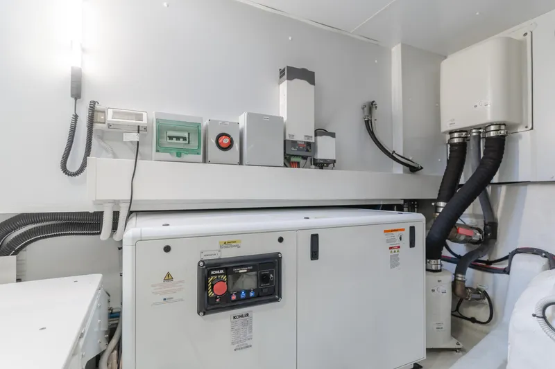 Slide: The Image of Engine room of 2023 Azimut Magellano 66 yacht, featuring modern equipment and control systems. - 17