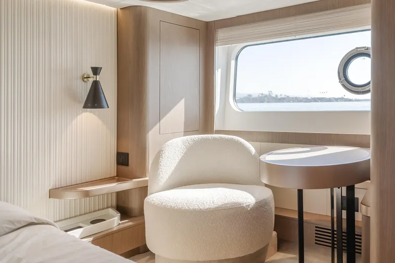 Slide: The Image of Luxurious interior of 2023 Azimut Magellano 66 yacht with modern seating and window view. - 25