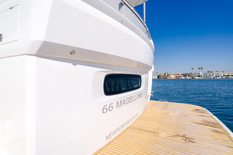 Slide: The Image of Azimut Magellano 66 yacht, 2023 model, docked by the water on a sunny day. - 31