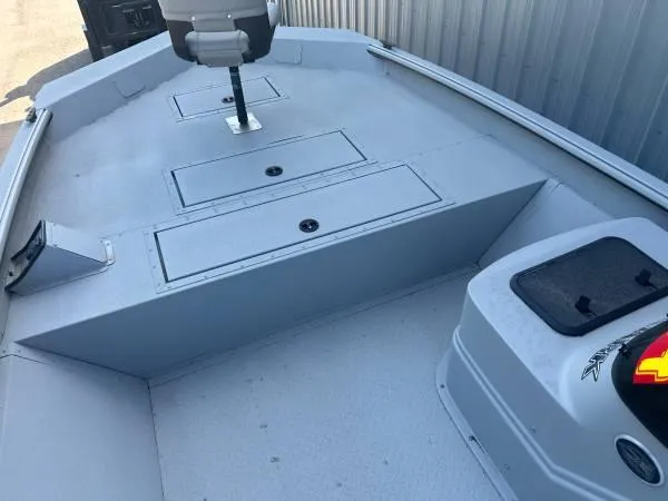 Slide: The Image of 2024 SeaArk Shadow 20 v boat interior with storage compartments and seating. - 4