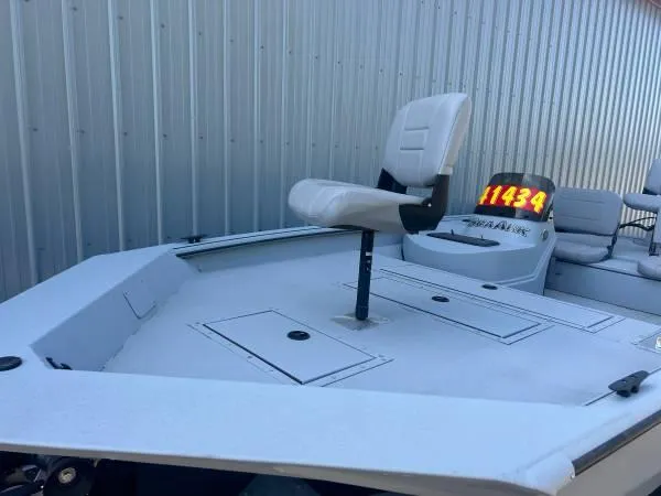 Slide: The Image of 2024 SeaArk Shadow 20 v boat with elevated seat and storage compartments. - 5