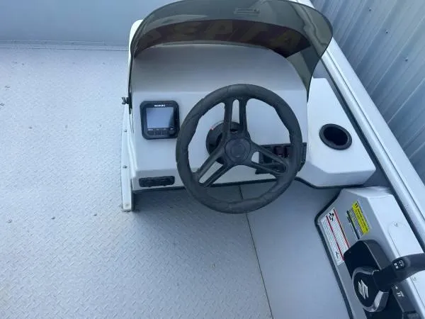 Slide: The Image of 2024 SeaArk Shadow 20 v boat console with steering wheel and controls. - 6