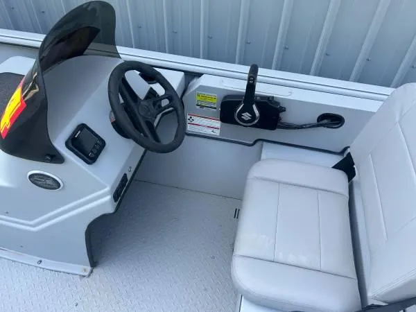 Slide: The Image of 2024 SeaArk Shadow 20 v boat interior with steering wheel and control panel. - 7