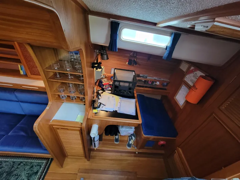 Slide: The Image of Cozy wooden interior of a 1978 Fuji 40 sailboat with seating and storage. - 10