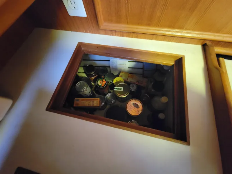 Slide: The Image of Hidden storage compartment with canned goods and bottles on a Fuji 40, 1978 model. - 14