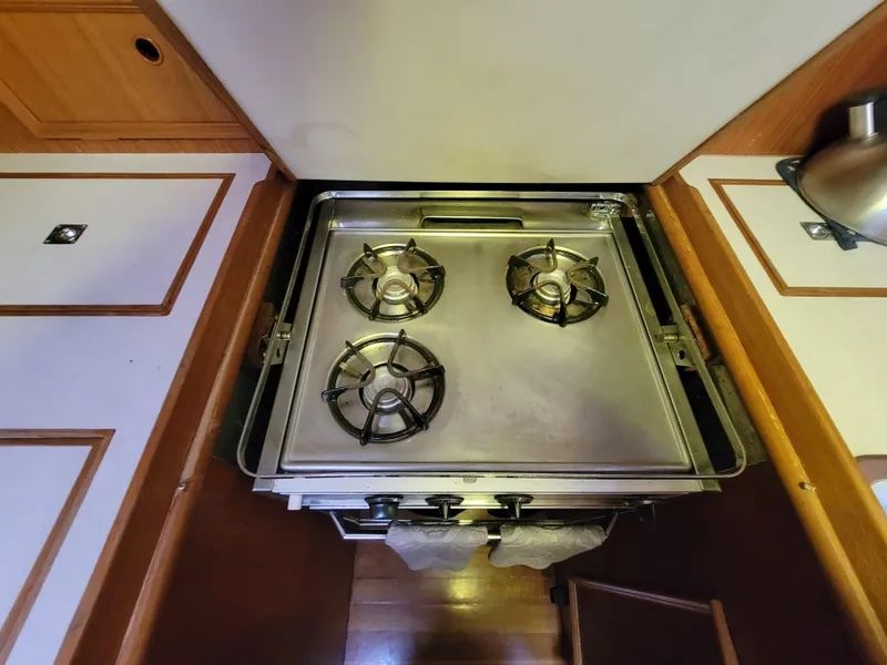 Slide: The Image of Vintage Fuji 40 stove from 1978 with three burners in a wooden kitchen setting. - 15