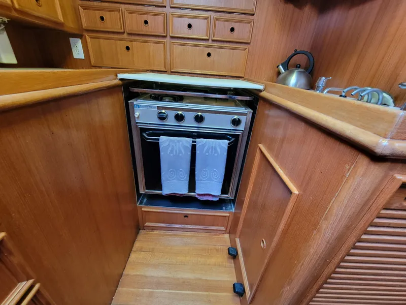 Slide: The Image of Wooden boat kitchen with stove, cabinets, and kettle, Fuji 40, 1978 model. - 17