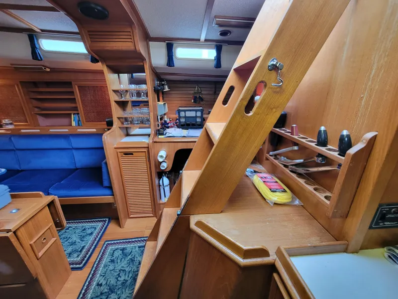 Slide: The Image of Vintage 1978 Fuji 40 yacht interior with wooden cabinetry and blue seating. - 18