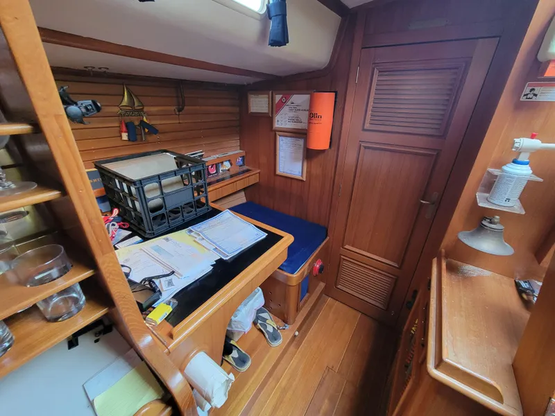 Slide: The Image of Cozy wooden cabin interior of a 1978 Fuji 40 sailboat with desk and storage. - 21