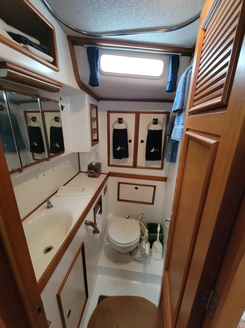 Slide: The Image of Vintage 1978 Fuji 40 yacht bathroom with wooden accents and compact design. - 30