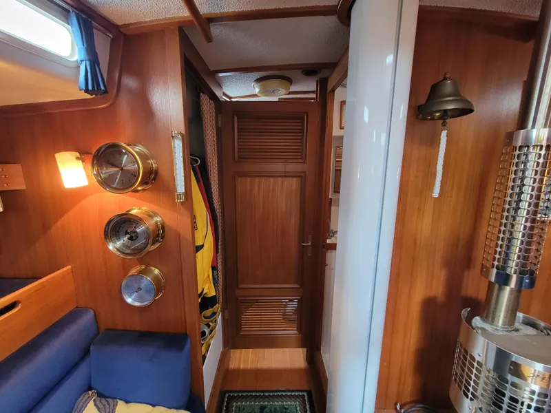 Slide: The Image of Cozy 1978 Fuji 40 sailboat interior with wood paneling and nautical decor. - 34