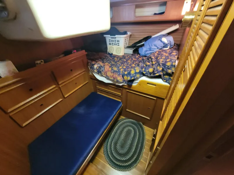 Slide: The Image of Cozy cabin interior of 1978 Fuji 40 sailboat with wooden furnishings and bedding. - 41