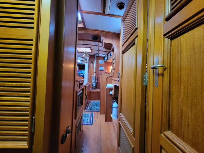 Slide: The Image of Interior of a 1978 Fuji 40 sailboat with wooden paneling and nautical decor. - 45