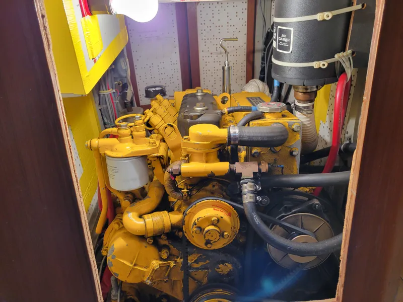 Slide: The Image of Yellow engine in a Fuji 40 boat, 1978 model, with visible hoses and components. - 46