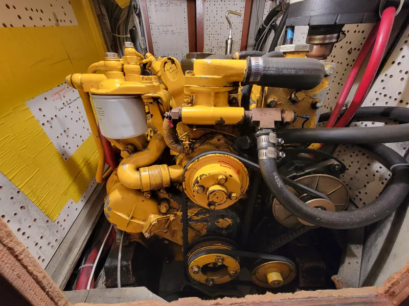 Slide: The Image of Yellow engine in a Fuji 40 boat, 1978 model, with visible hoses and components. - 48