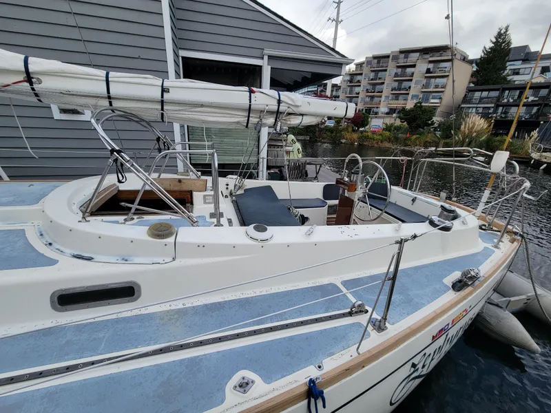 Slide: The Image of 1978 Fuji 40 sailboat docked near modern buildings and waterfront. - 5