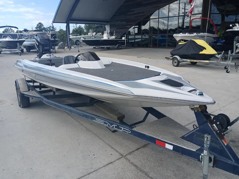 Slide: The Image of Allison 2002 XB boat on trailer, parked at marina, 1988 model. - 4