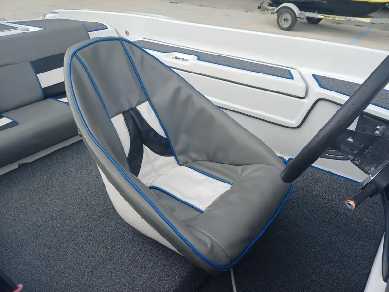 Slide: The Image of Allison 2002 XB boat interior with gray and blue seating, steering wheel visible. - 6