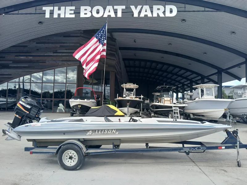 Slide: The Image of Allison 2002 XB boat on trailer at The Boat Yard, American flag displayed. - 9