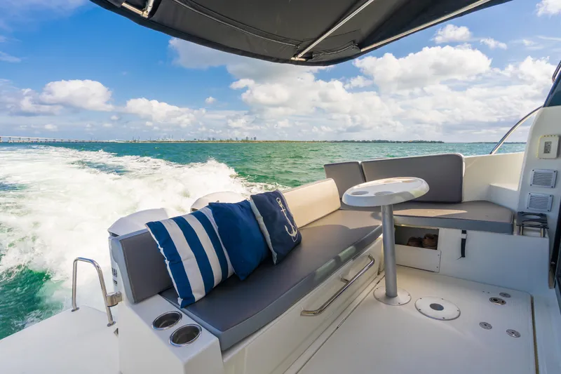 Slide: The Image of Jeanneau NC 1095 boat interior, 2019 model, cruising on open water with seating area. - 14