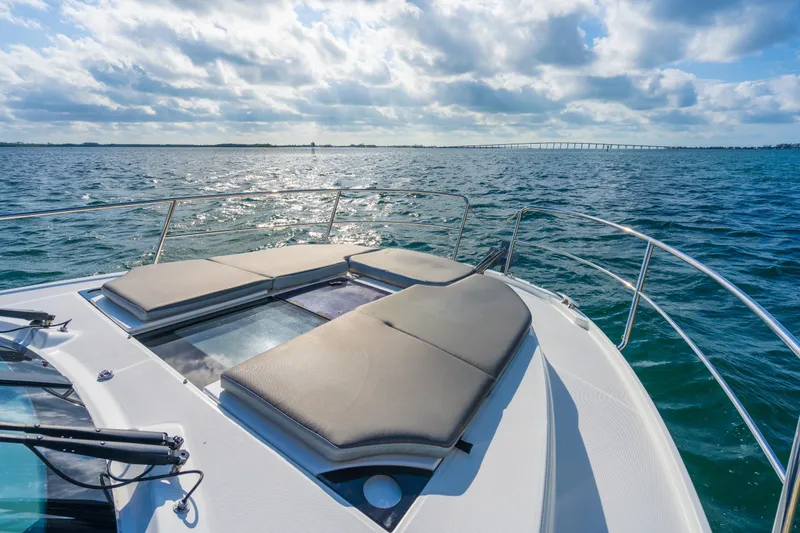 Slide: The Image of 2019 Jeanneau NC 1095 boat with sun pads on deck, ocean view. - 16