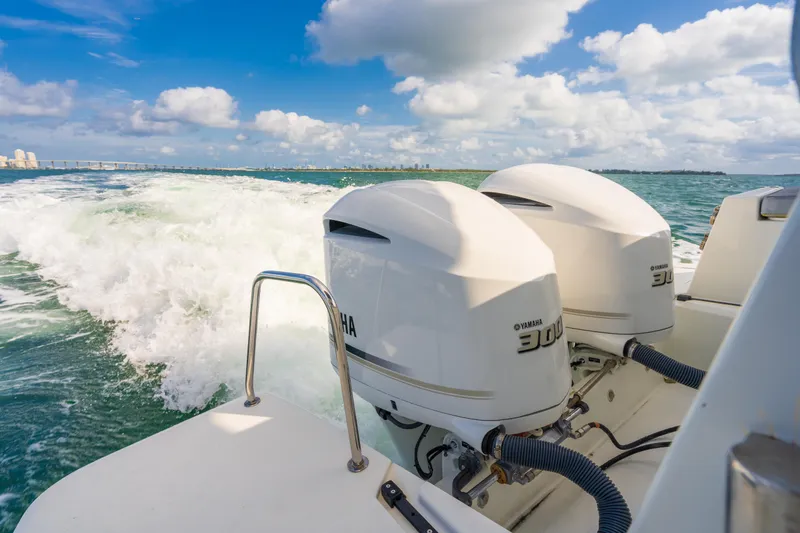 Slide: The Image of Jeanneau NC 1095 boat with dual Yamaha engines cruising on open water, 2019 model. - 17