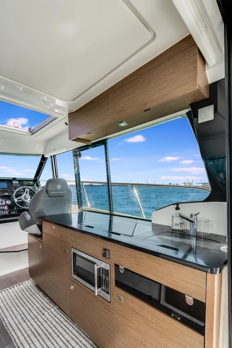 Slide: The Image of Interior of 2019 Jeanneau NC 1095 boat with modern kitchen and ocean view. - 22