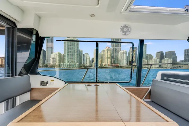 Slide: The Image of Interior view of 2019 Jeanneau NC 1095 yacht with city skyline in background. - 25