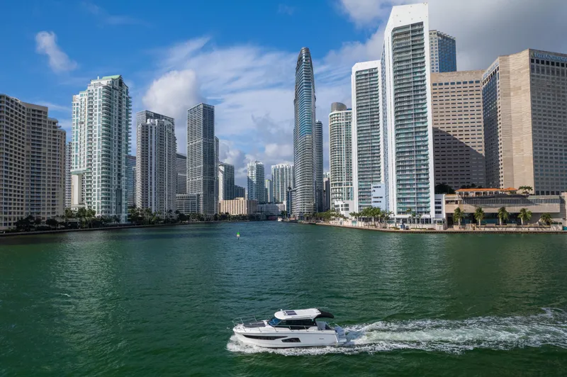 Slide: The Image of Jeanneau NC 1095 boat cruising in city waterfront with skyscrapers, 2019 model. - 3
