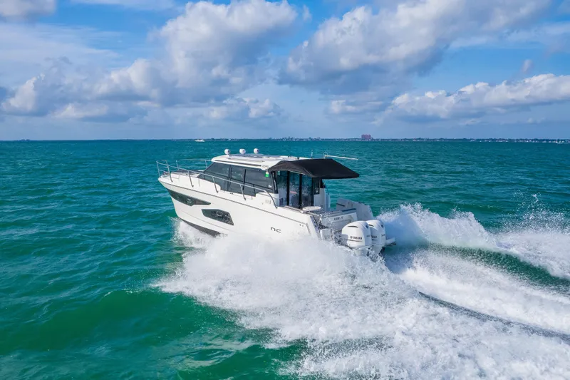 Slide: The Image of 2019 Jeanneau NC 1095 cruising on open sea under blue skies. - 8