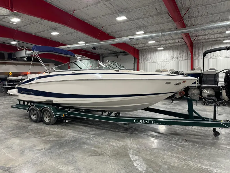 The Image of 2011 Regal 2500 LSR boat on trailer in indoor showroom. - 1