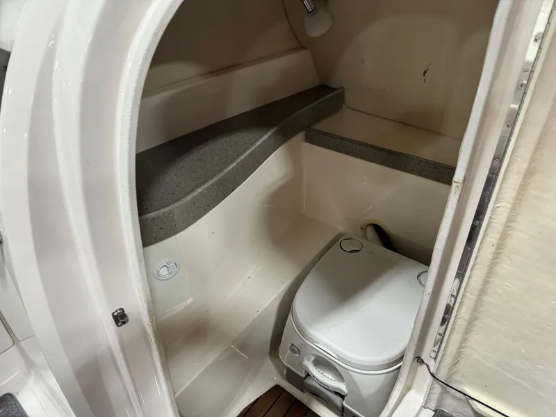 Slide: The Image of 2011 Regal 2500 LSR boat interior with compact marine toilet. - 10
