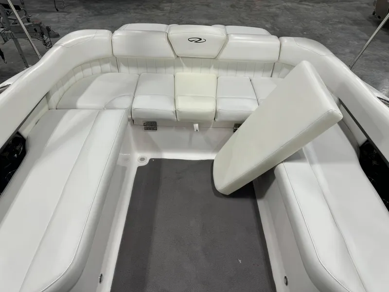 Slide: The Image of 2011 Regal 2500 LSR boat interior with white seating and gray flooring. - 11