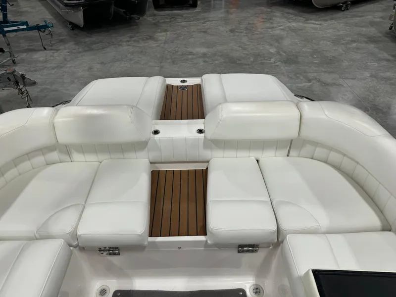 Slide: The Image of 2011 Regal 2500 LSR boat interior with white seating and wooden accents. - 12
