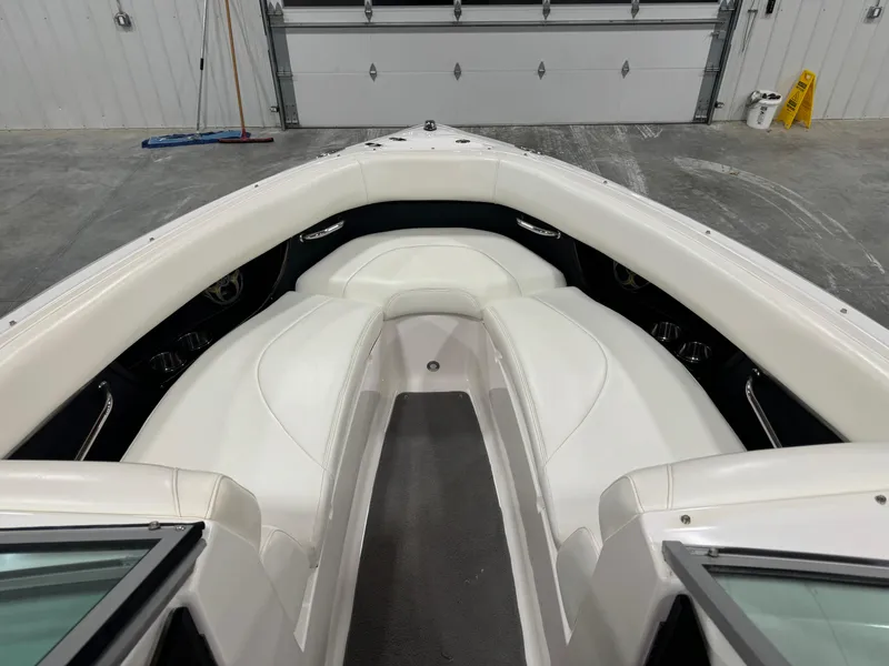 Slide: The Image of 2011 Regal 2500 LSR boat interior with white seating and gray flooring. - 14