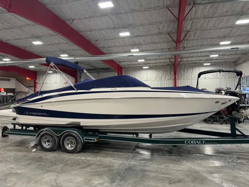 Slide: The Image of 2011 Regal 2500 LSR boat on trailer in indoor storage facility. - 18