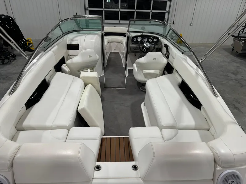 Slide: The Image of 2011 Regal 2500 LSR boat interior with white seating and modern dashboard. - 6