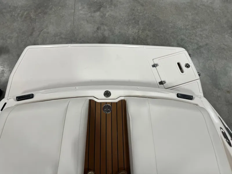 Slide: The Image of 2011 Regal 2500 LSR boat with white deck and wood accents. - 7