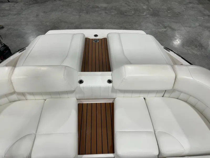 Slide: The Image of 2011 Regal 2500 LSR boat with white cushioned seating and wooden deck. - 8