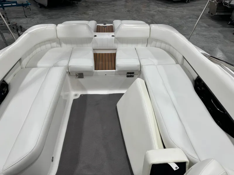 Slide: The Image of 2011 Regal 2500 LSR boat interior with white seating and wood accents. - 9