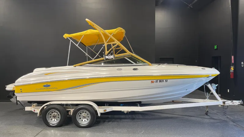 Slide: The Image of 2005 Chaparral 210 SSi boat with yellow canopy on trailer in showroom. - 1